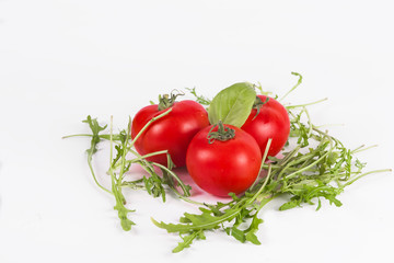 Fresh rucola with tomatoes isolated on white