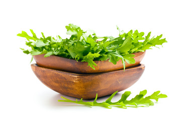arugula leaves in wooden bowl