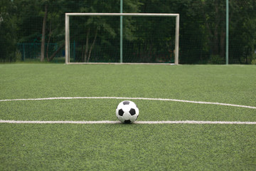 Classic black and white ball for playing soccer on sports ground