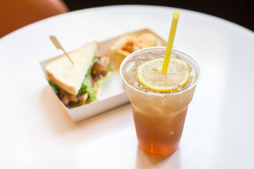Iced tea and lemon with sandwiches