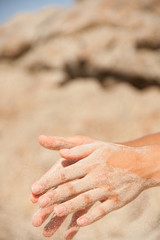 sand flows through the female hands