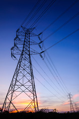 Fototapeta premium High voltage transmission tower in sunset scene twilight