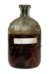 Vintage sealed bottle of aged spirit with chipped oak wood insid