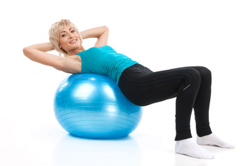 aged lady lying on fitness ball.