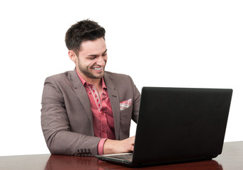 Smiling business man working on his laptop.