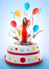 Beautiful woman jumping out of the cake