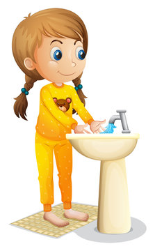 A cute young girl washing her hands