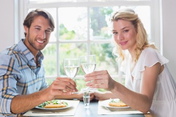 Cute smiling couple having a meal together