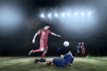 Naklejka premium Composite image of football players tackling for the ball