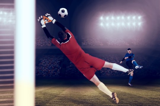 Composite image of goalkeeper in red jumping up