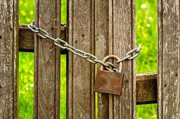 Old wooden fence with a locked door