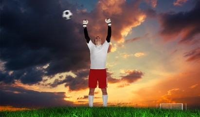 Fototapeta na wymiar Composite image of goalkeeper in white cheering