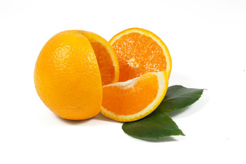 Sliced orange fruit with green leaves on white background