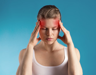 Stressed female having migraine shown with red spots