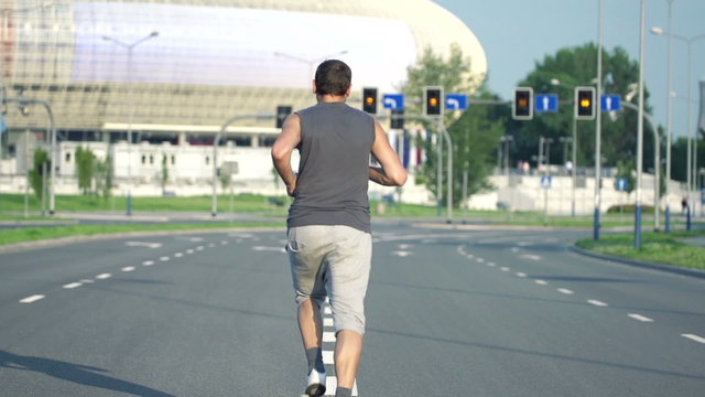 Man jogging on the street in the city, super slow motion