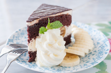 close up of a chocolate cream cake on plate