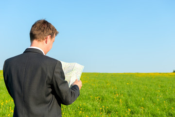 traveler lost in a jacket with a map