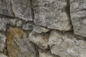 Old masonry of travertine at an angle to the observer