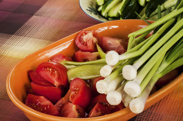 Freshly picked and cut organic tomatoes, onions and cucumbers