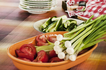 Freshly picked and cut organic tomatoes, onions and cucumbers