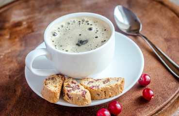 A cup of coffee with biscotti