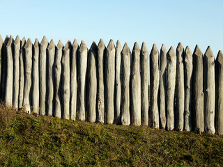 wooden palisade of the protective fence - obrazy, fototapety, plakaty