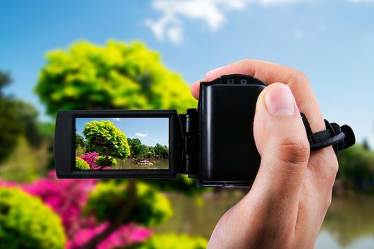 Video camera or camcorder recording flora in japanese garden