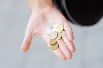 Woman holding golden and silvery coins