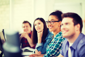 students with computers studying at school