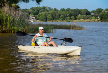 Fototapeta na wymiar Man Fishing in Kayak