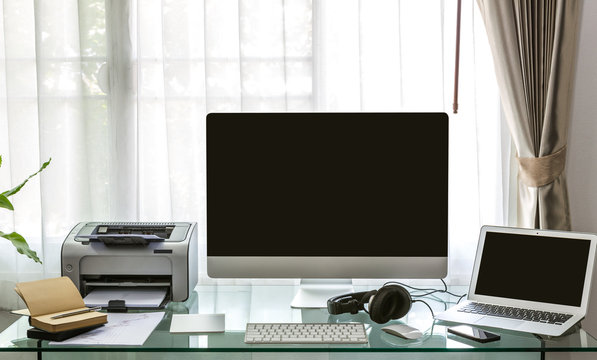 Modern home office with computer and labtop