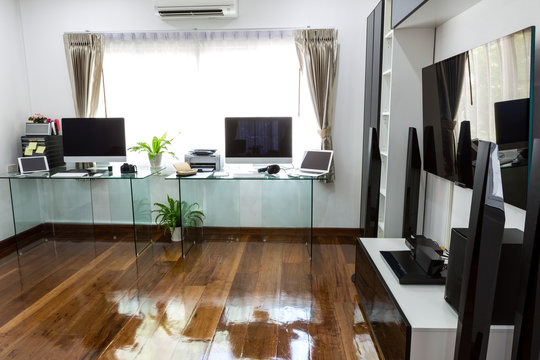 Modern office with computer and labtop with home theater