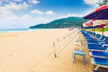 Beach chair and umbrella on sand beach