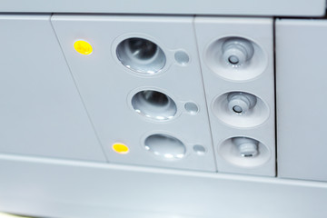 lights, air condition  signs panel above the seat on plane
