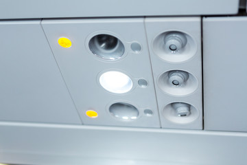 lights, air condition  signs panel above the seat on plane