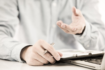 Businessman analyzing investment charts with laptop