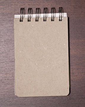brown blank note book on wood