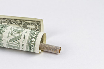 Cigarette wrapped in a 1 dollar bill