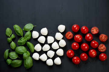 Naklejka na ściany i meble Italian flavors: green basil, mozzarella and cherry tomatoes