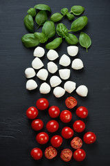 Italian ingredients: green basil, mozzarella and cherry tomatoes