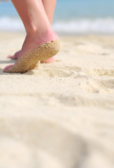 Women's legs on a beach