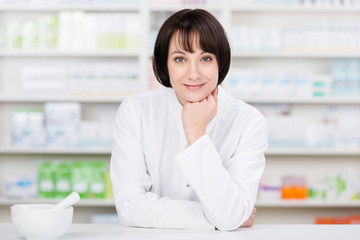 lächelnde apothekerin an der verkaufstheke