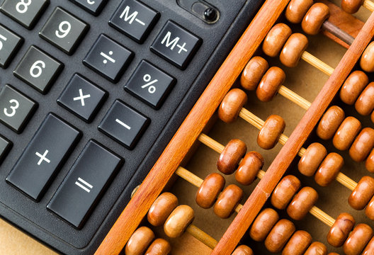 Ancient abacus and modern calculator