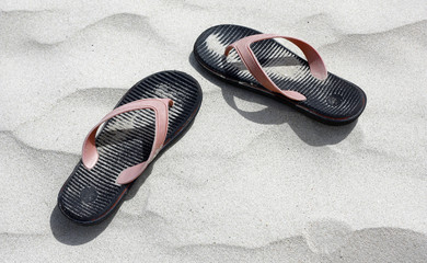 Flip flop on white sand