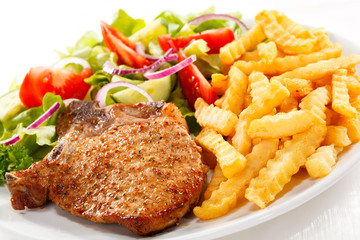 Pork chop, French fries and vegetables