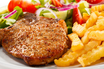 Pork chop, French fries and vegetables