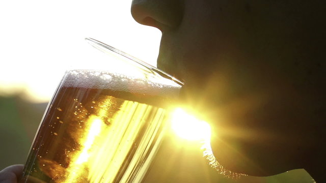 Man drinking beer on sunny day