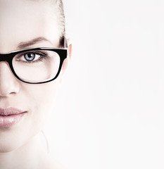 Close-up of lovely woman in optical eyeglasses - obrazy, fototapety, plakaty