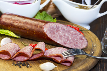 sausages on a wooden plate with vegetables in a restaurant