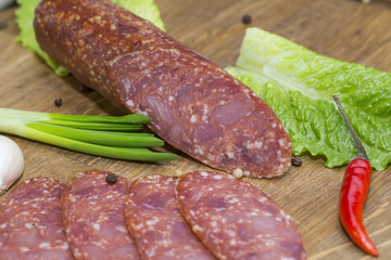 sausages on a wooden plate with vegetables in a restaurant